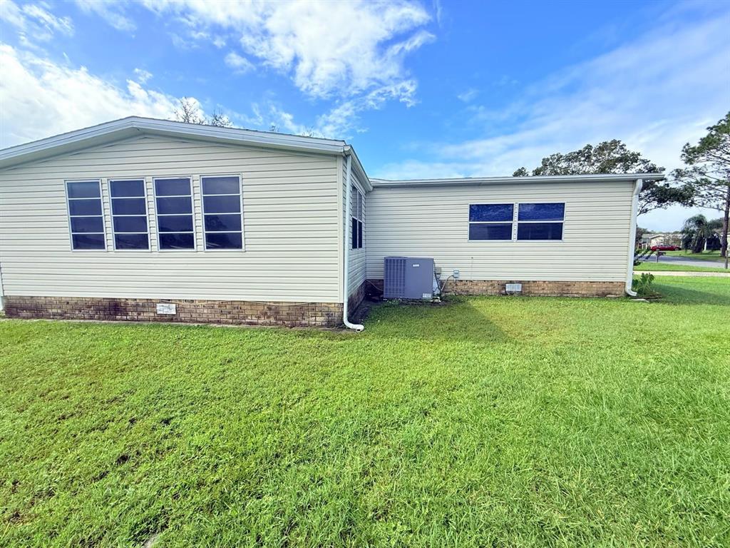 220 Ellsworth Drive Kissimmee, FL 34758 - Photo 5 of 40 a front view of house with yard and outdoor seating