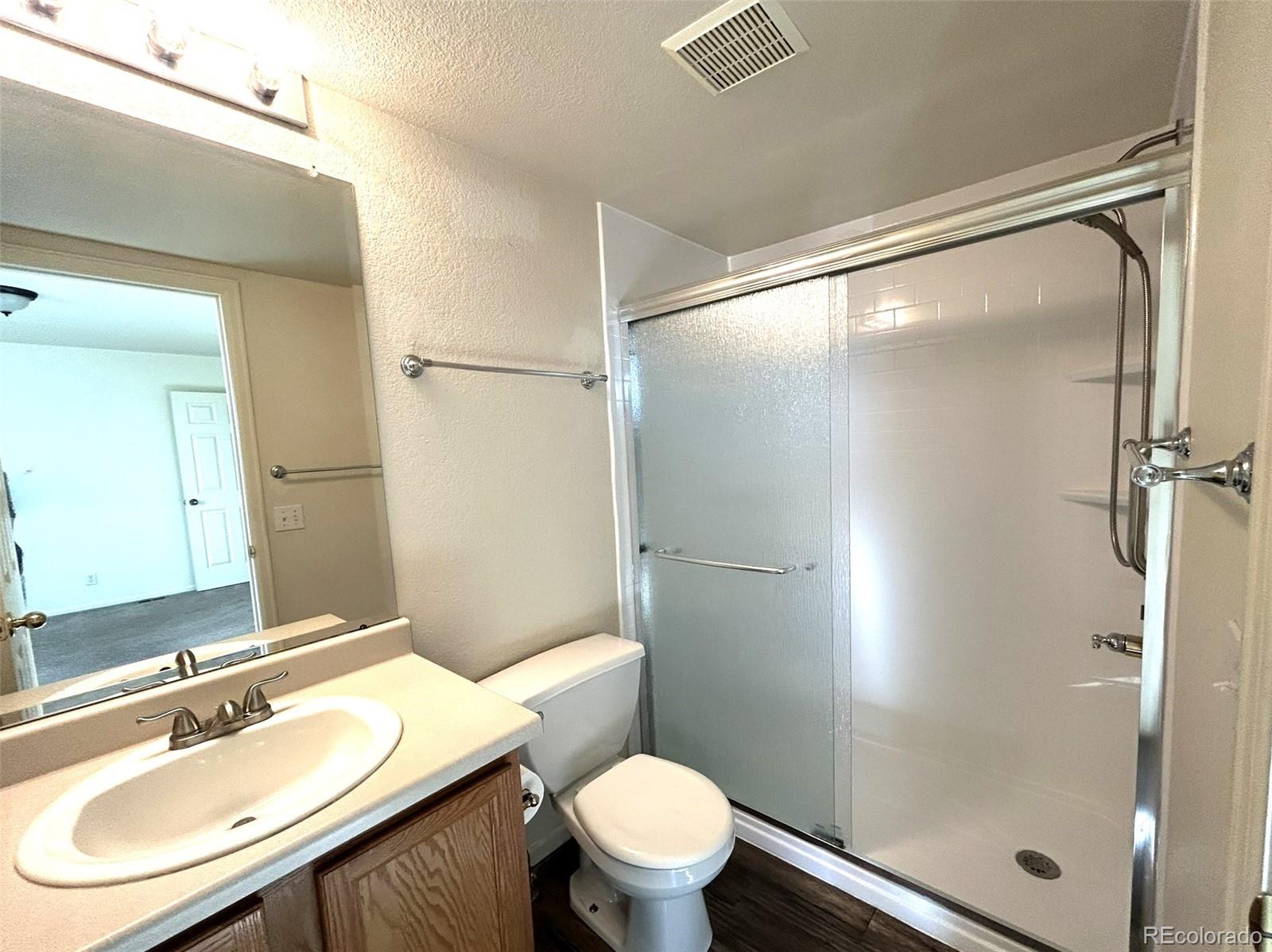 9325 Welby Rd Terrace Denver, CO 80229 - Photo 11 of 21 a bathroom with a sink toilet and shower