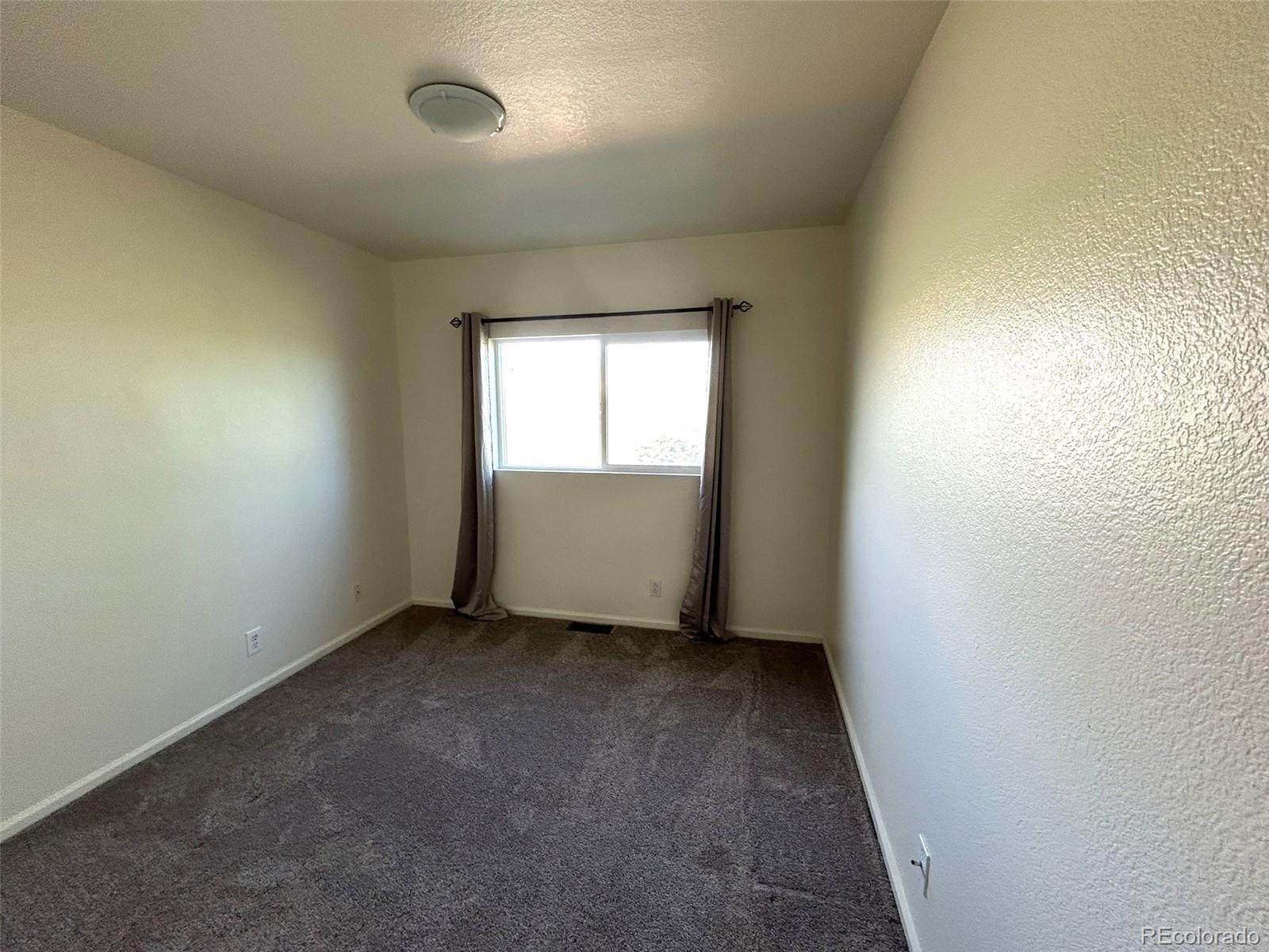 9325 Welby Rd Terrace Denver, CO 80229 - Photo 13 of 21 an empty room with window