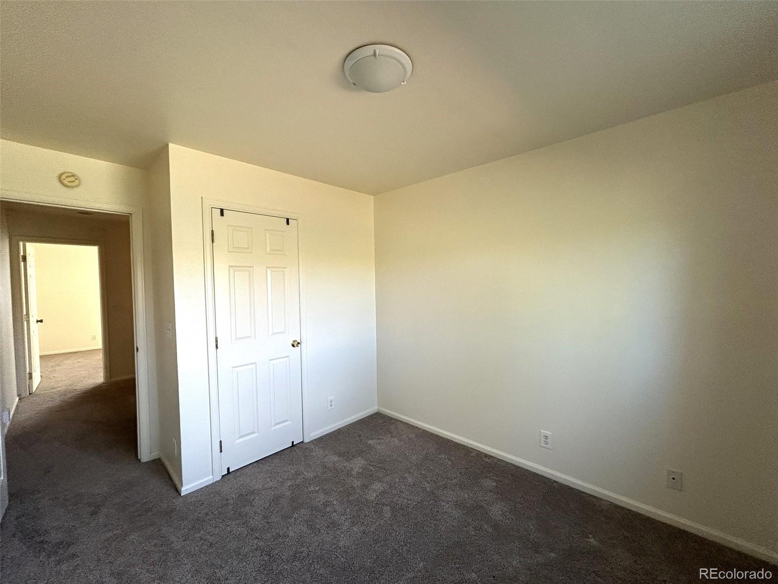 9325 Welby Rd Terrace Denver, CO 80229 - Photo 14 of 21 an empty room with a mirror