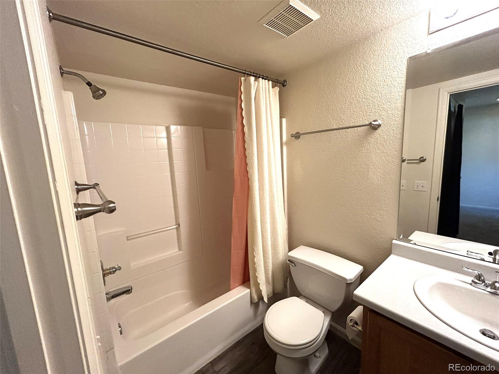 9325 Welby Rd Terrace Denver, CO 80229 - Photo 15 of 21 a white toilet sitting next to a bathroom sink