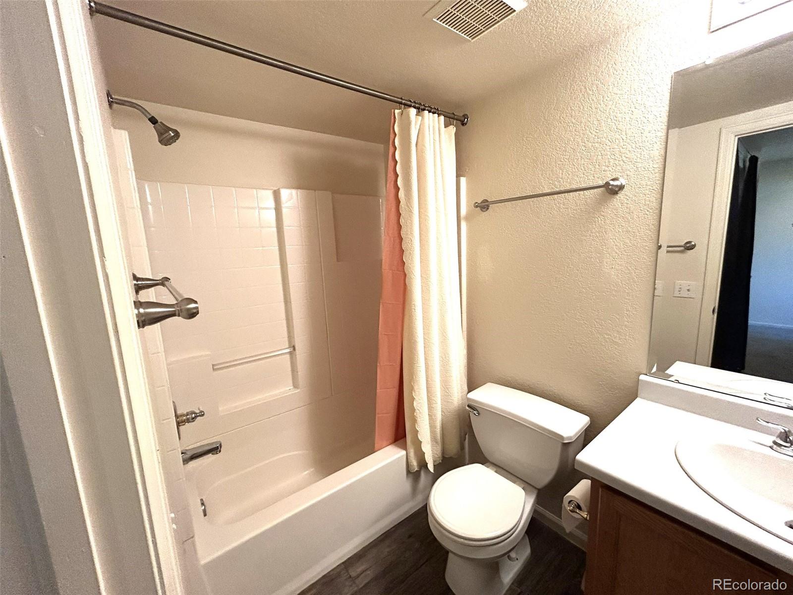 9325 Welby Rd Terrace Denver, CO 80229 - Photo 16 of 21 a white toilet sitting next to a bath tub