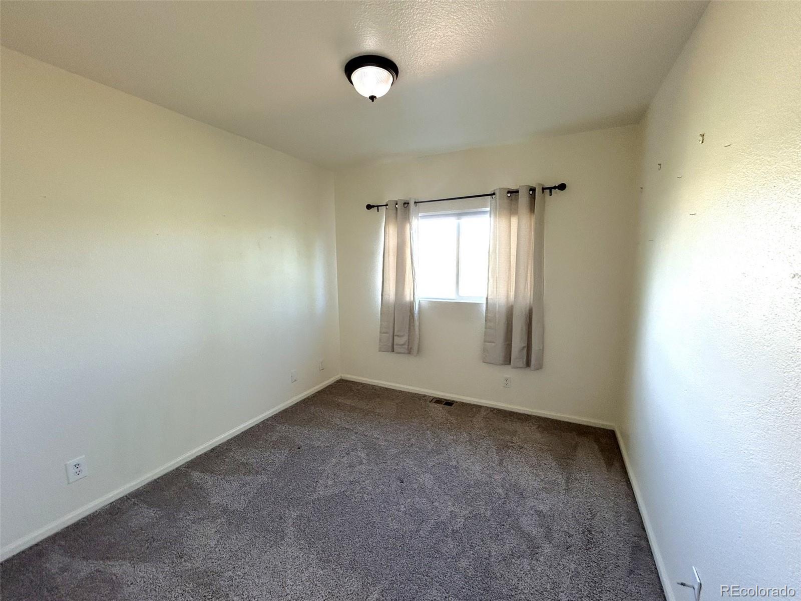 9325 Welby Rd Terrace Denver, CO 80229 - Photo 17 of 21 an empty room with windows