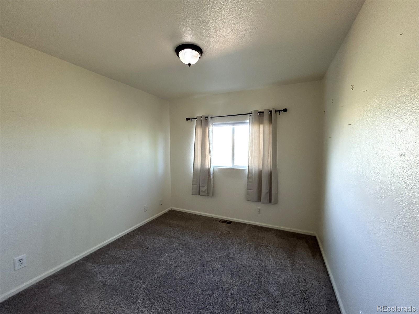 9325 Welby Rd Terrace Denver, CO 80229 - Photo 18 of 21 an empty room with windows
