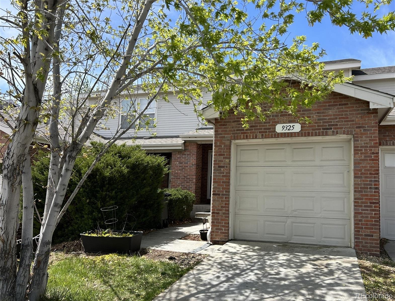 9325 Welby Rd Terrace Denver, CO 80229 - Photo 20 of 21 a front view of a house with a tree