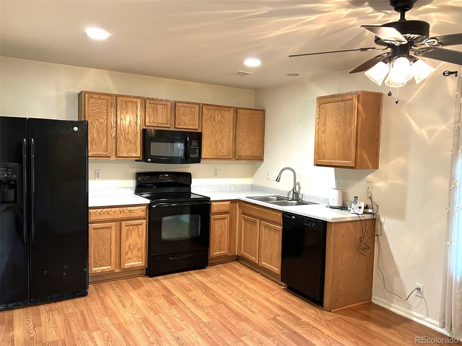 9325 Welby Rd Terrace Denver, CO 80229 - Photo 2 of 21 a kitchen with a sink stove and refrigerator