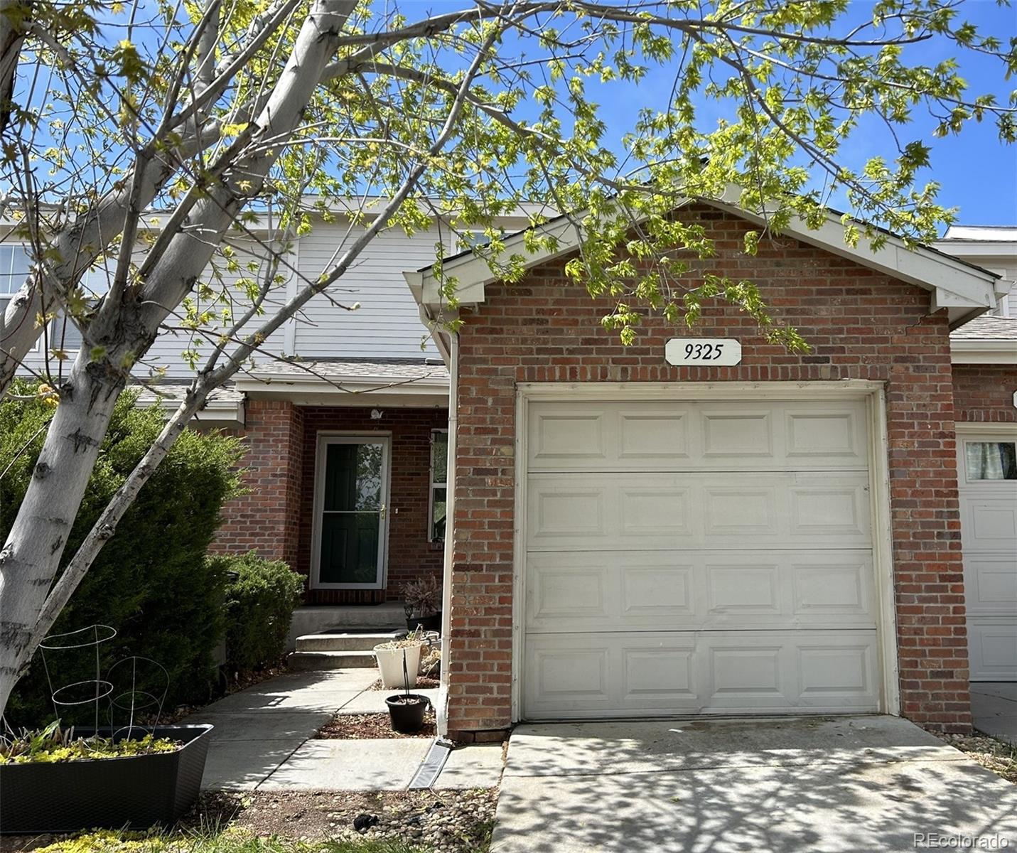 9325 Welby Rd Terrace Denver, CO 80229 - Photo 21 of 21 a house with a tree in front of it