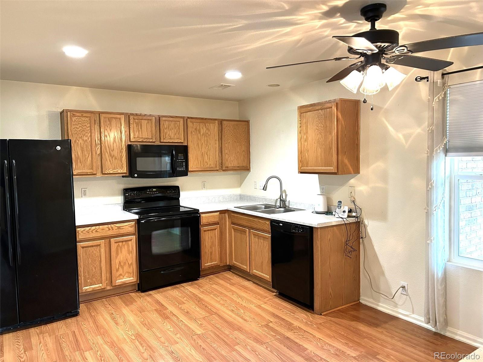 9325 Welby Rd Terrace Denver, CO 80229 - Photo 3 of 21 a kitchen with stainless steel appliances granite countertop a sink stove and refrigerator