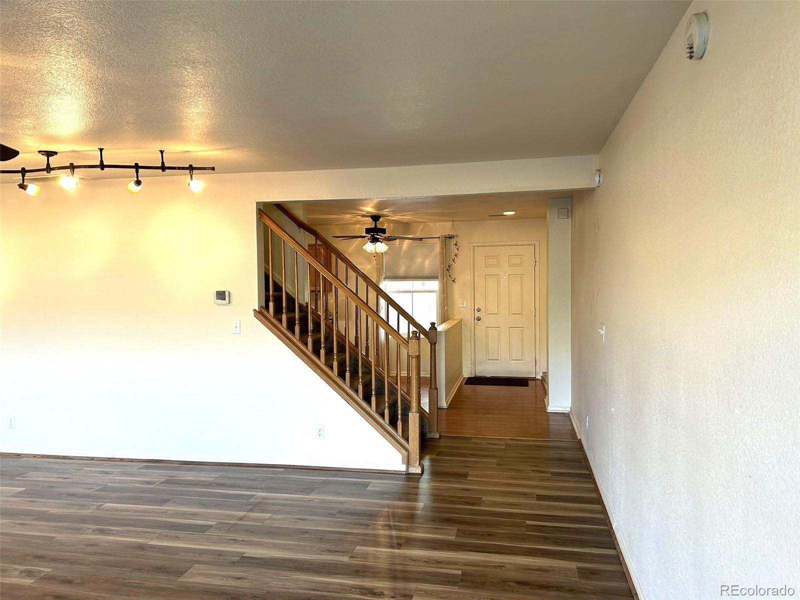 9325 Welby Rd Terrace Denver, CO 80229 - Photo 6 of 21 a view of a hallway with wooden floor