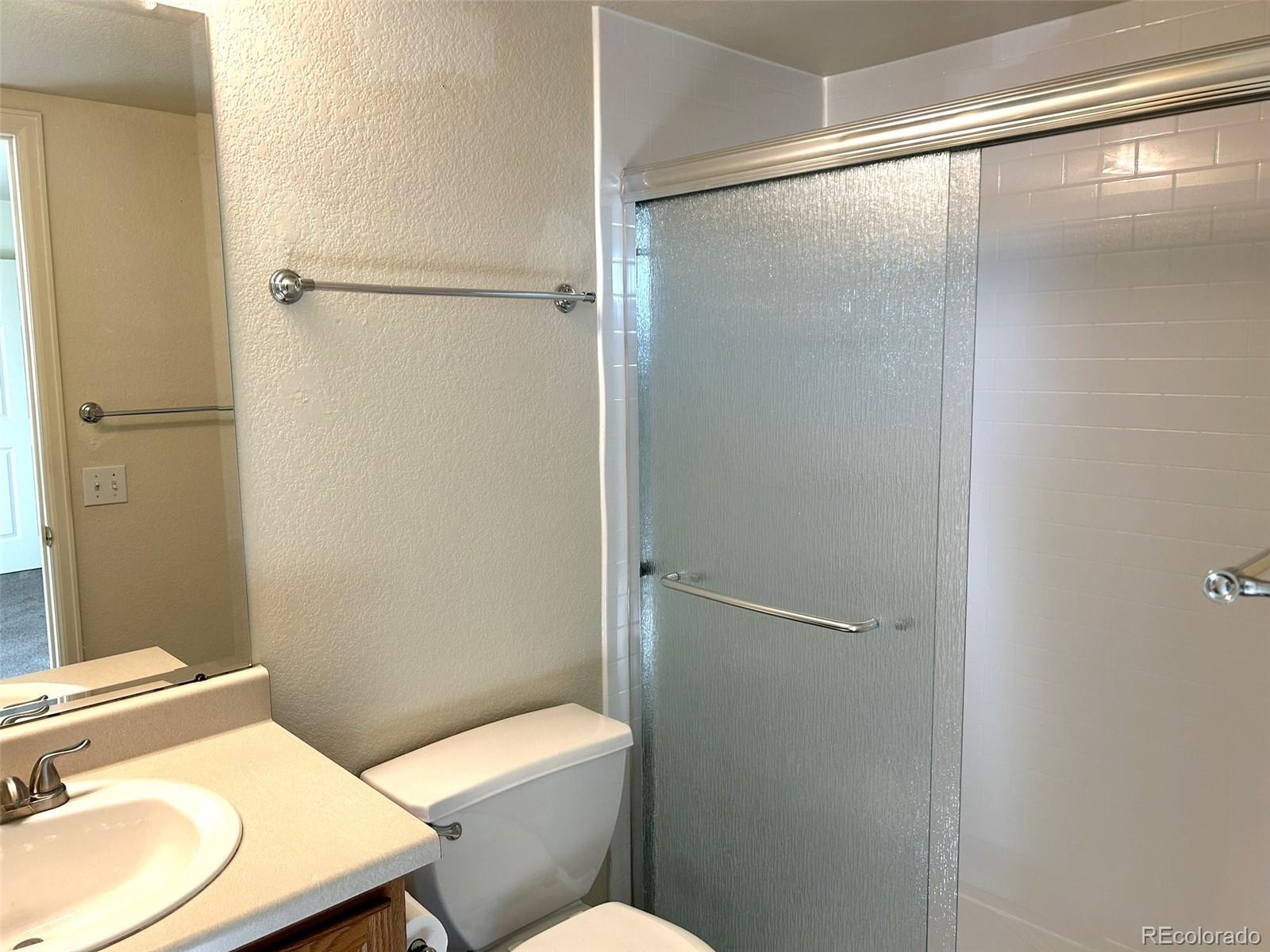 9325 Welby Rd Terrace Denver, CO 80229 - Photo 9 of 21 a bathroom with a sink toilet and shower