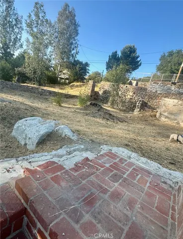 an aerial view of a house with a yard and lake view