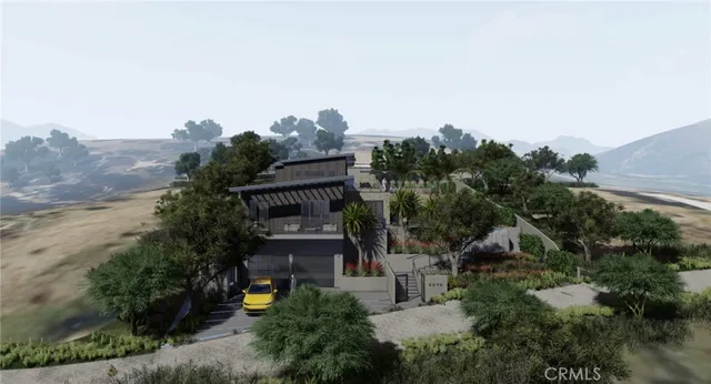 an aerial view of a house with a yard and mountain view in back