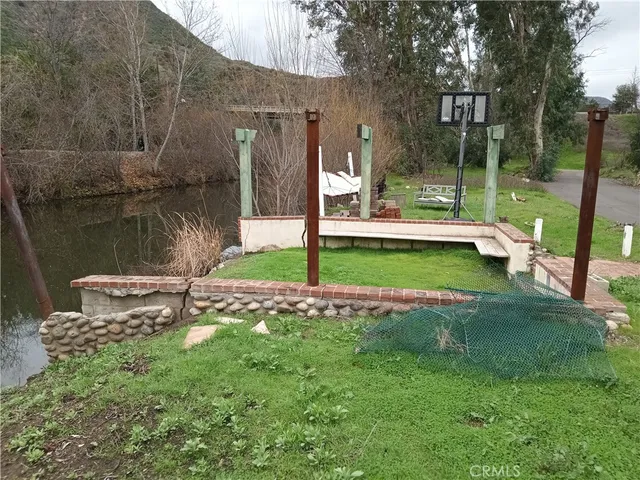 a view of a street with a wooden fence
