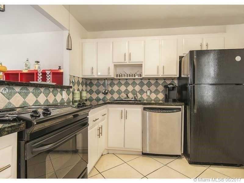 20400 West Country Club Drive, Unit 410 Aventura, FL 33180 - Photo 4 of 7 a kitchen with stainless steel appliances a refrigerator sink and cabinets