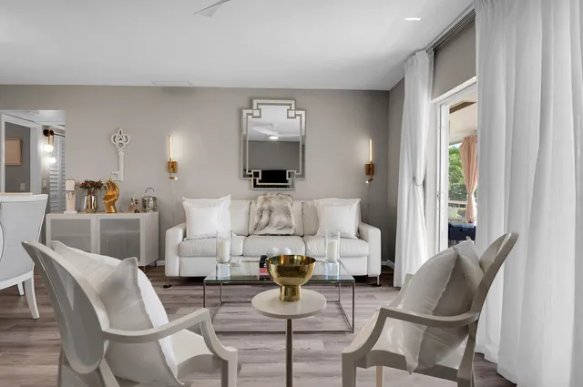 a living room with furniture and a potted plant