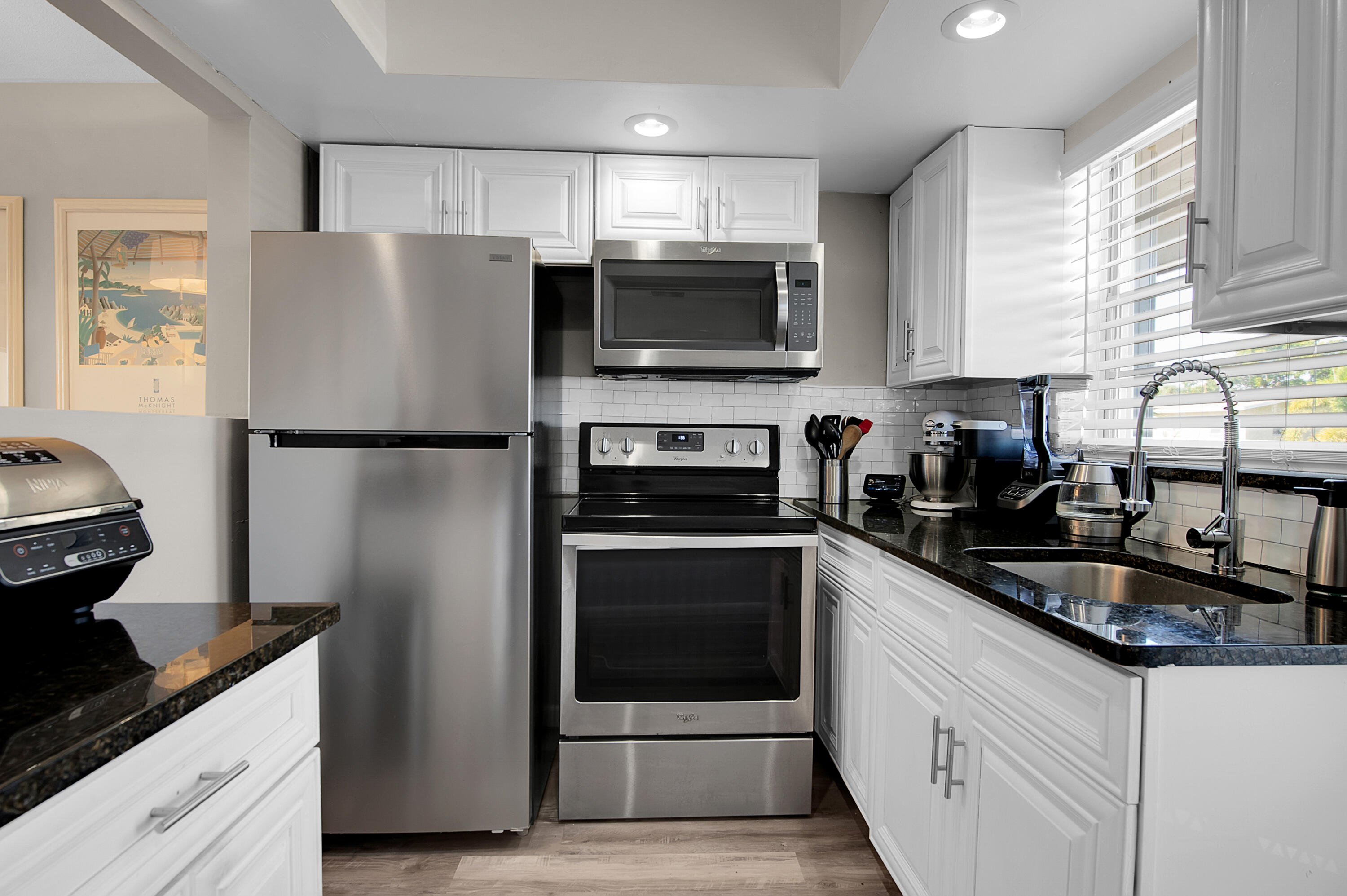312 Northeast 17th Avenue, Unit 202 Boynton Beach, FL 33435 - Photo 12 of 44 a kitchen with a refrigerator and a sink