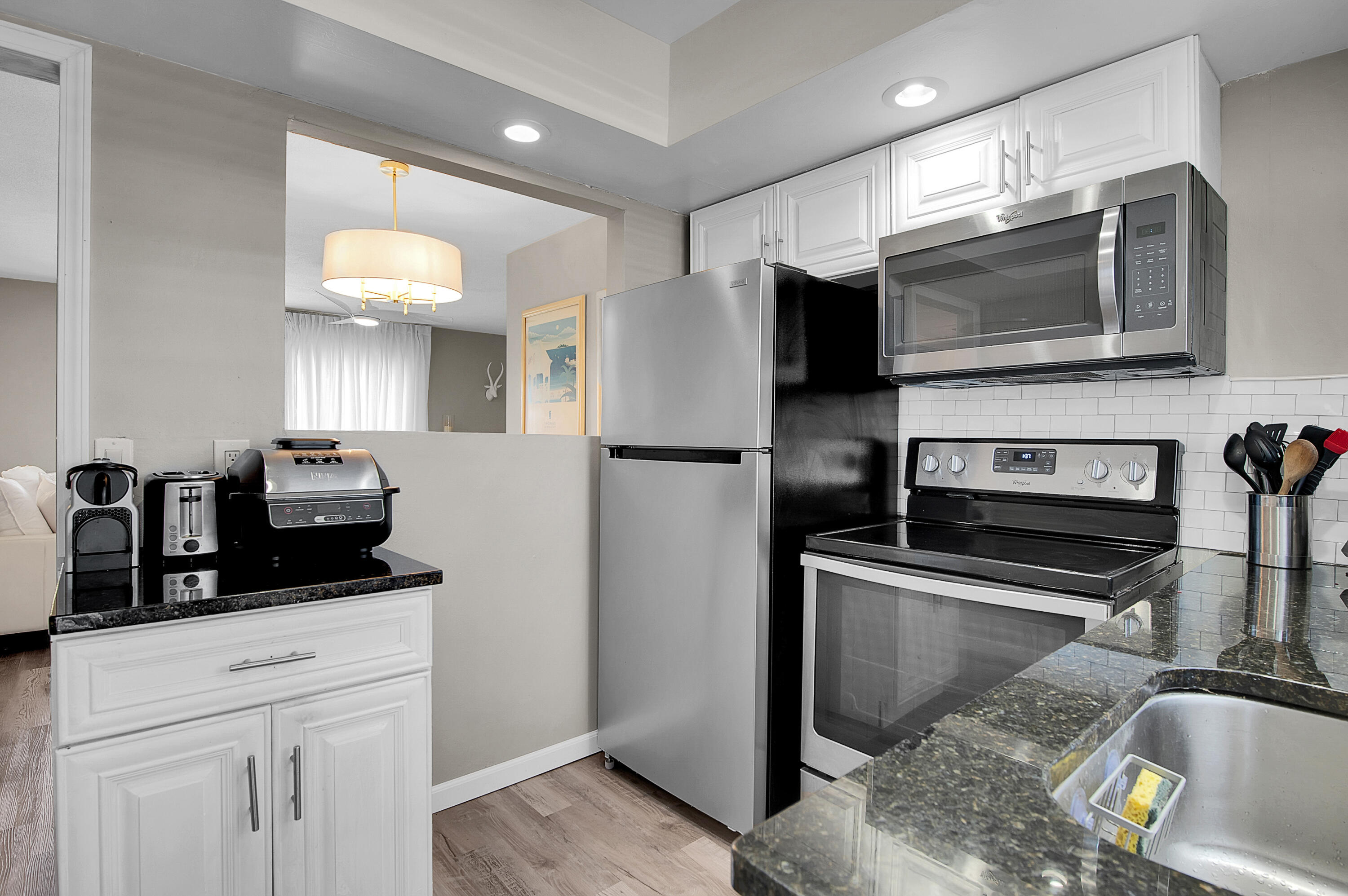 312 Northeast 17th Avenue, Unit 202 Boynton Beach, FL 33435 - Photo 13 of 44 a kitchen with a refrigerator and a sink