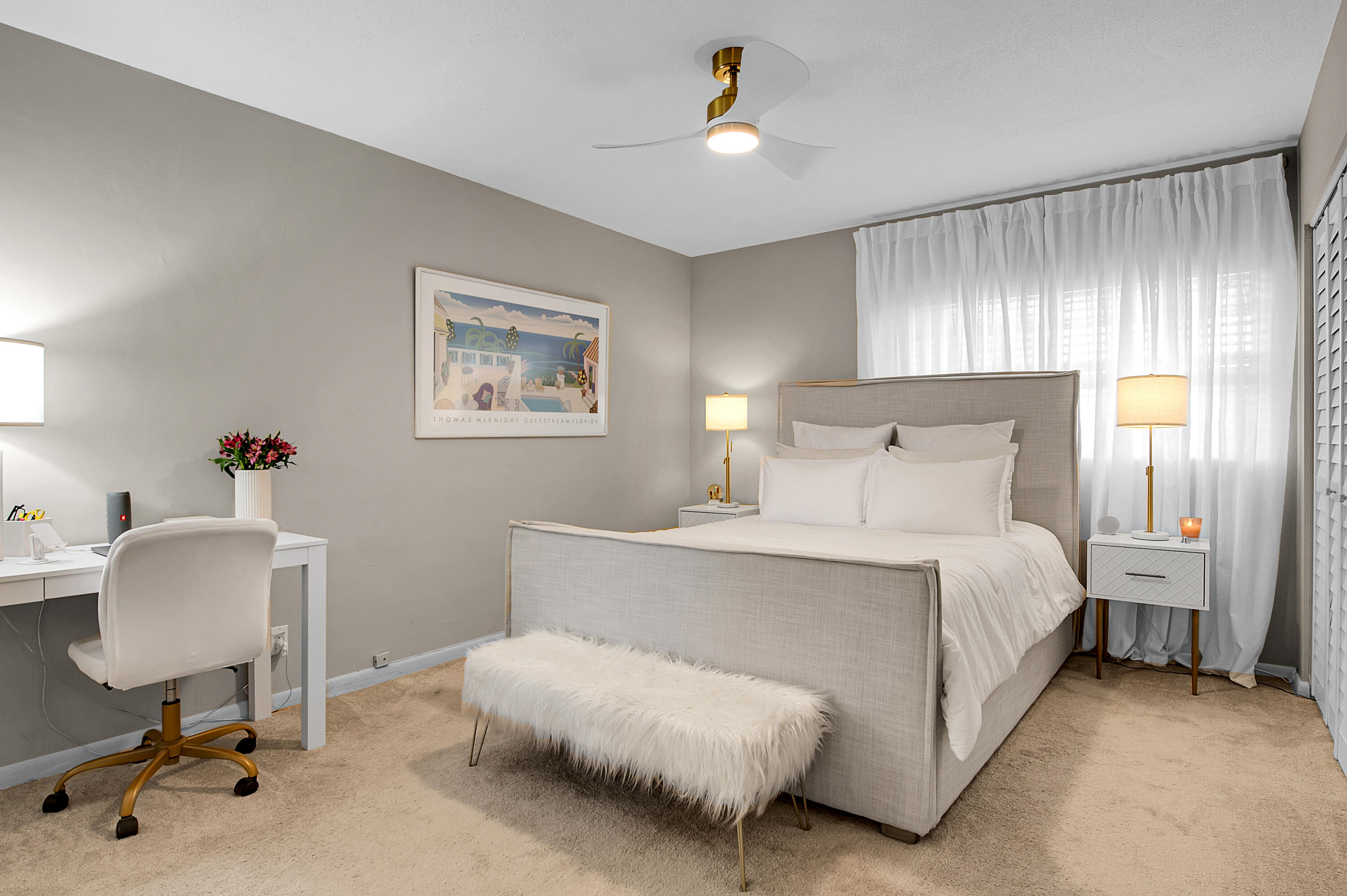 312 Northeast 17th Avenue, Unit 202 Boynton Beach, FL 33435 - Photo 16 of 44 a bedroom with a bed and a chandelier