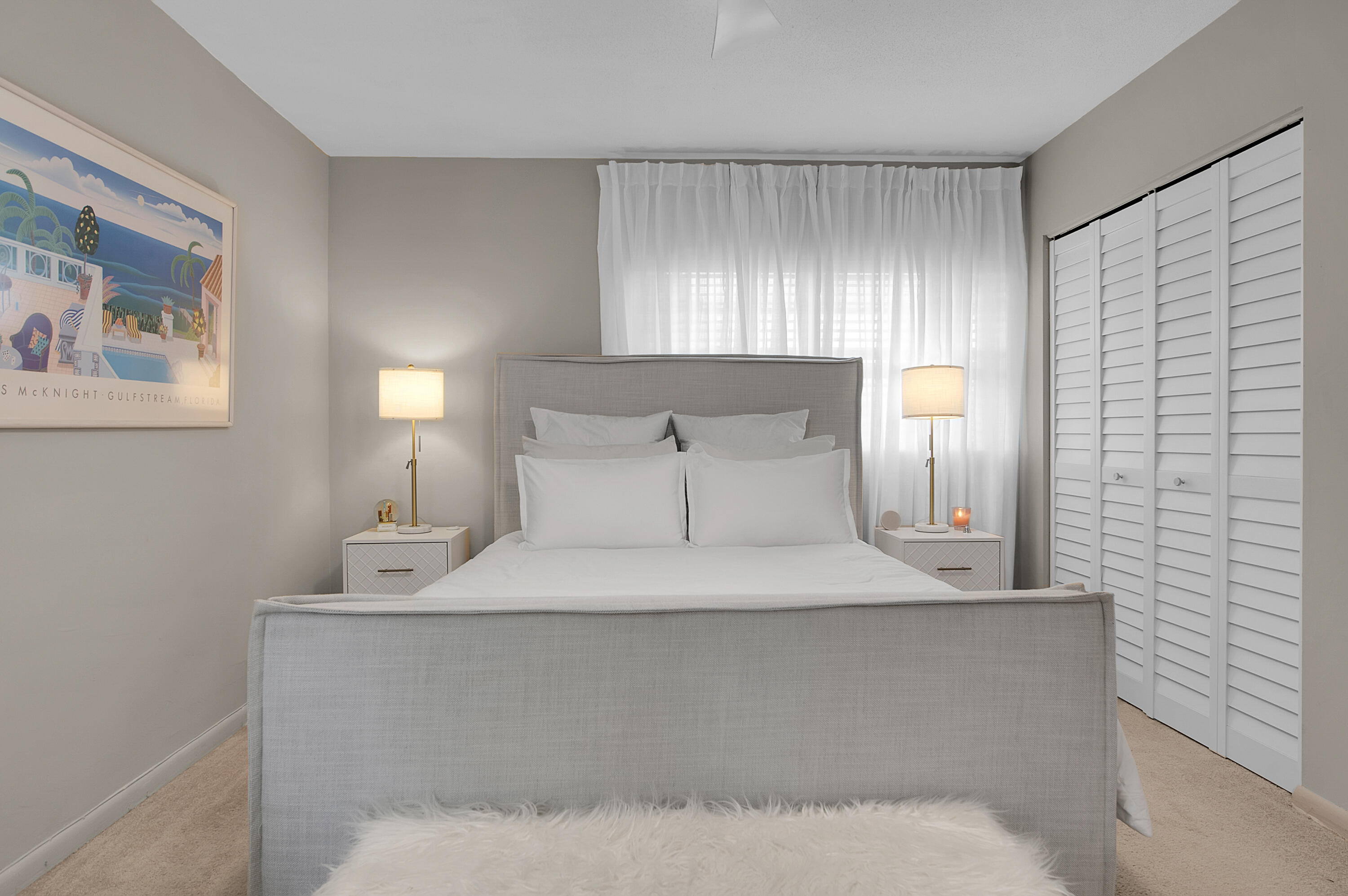 312 Northeast 17th Avenue, Unit 202 Boynton Beach, FL 33435 - Photo 17 of 44 a large bed sitting in a bedroom next to a window