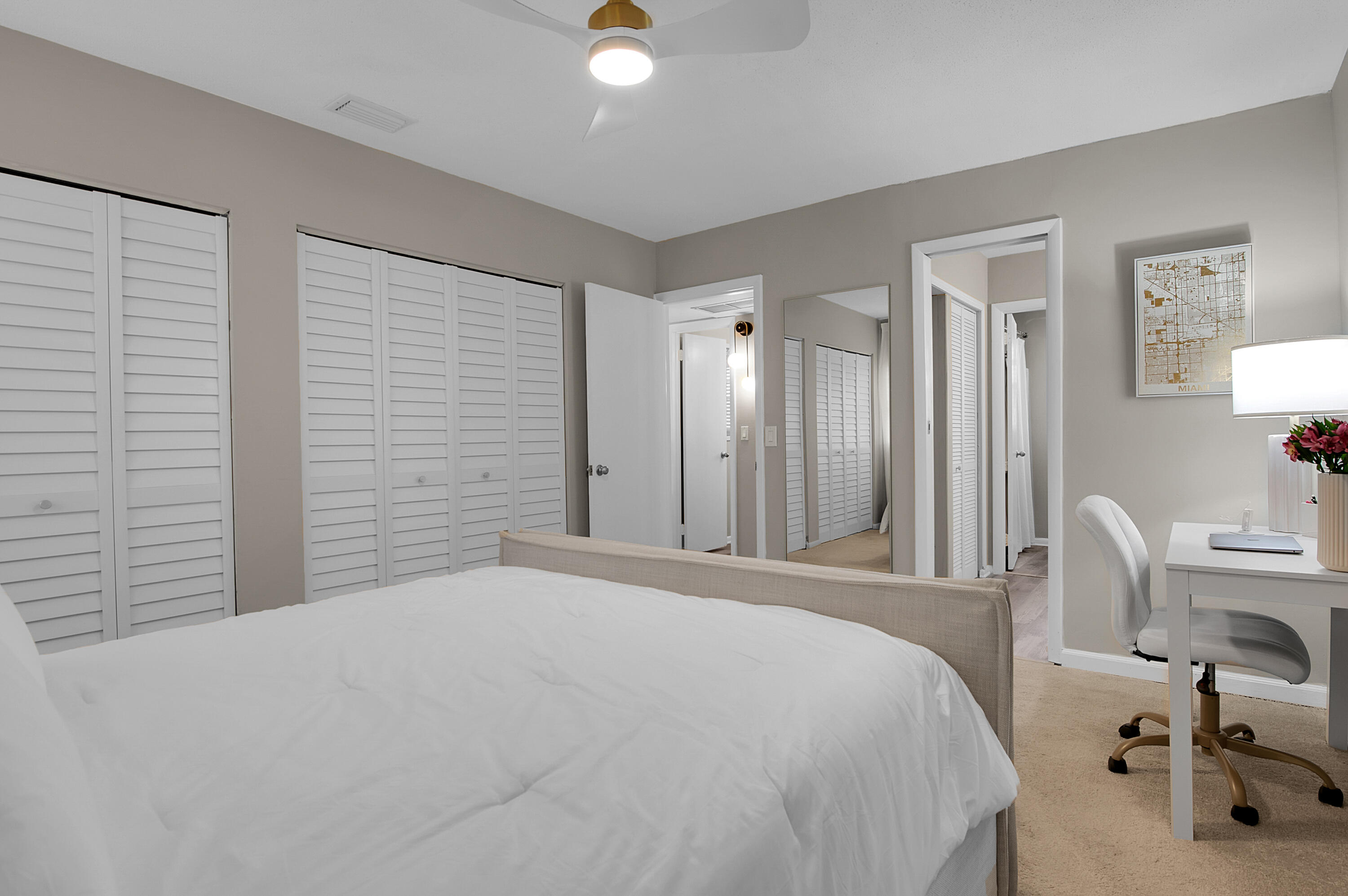 312 Northeast 17th Avenue, Unit 202 Boynton Beach, FL 33435 - Photo 18 of 44 a bedroom with a bed and a table chair