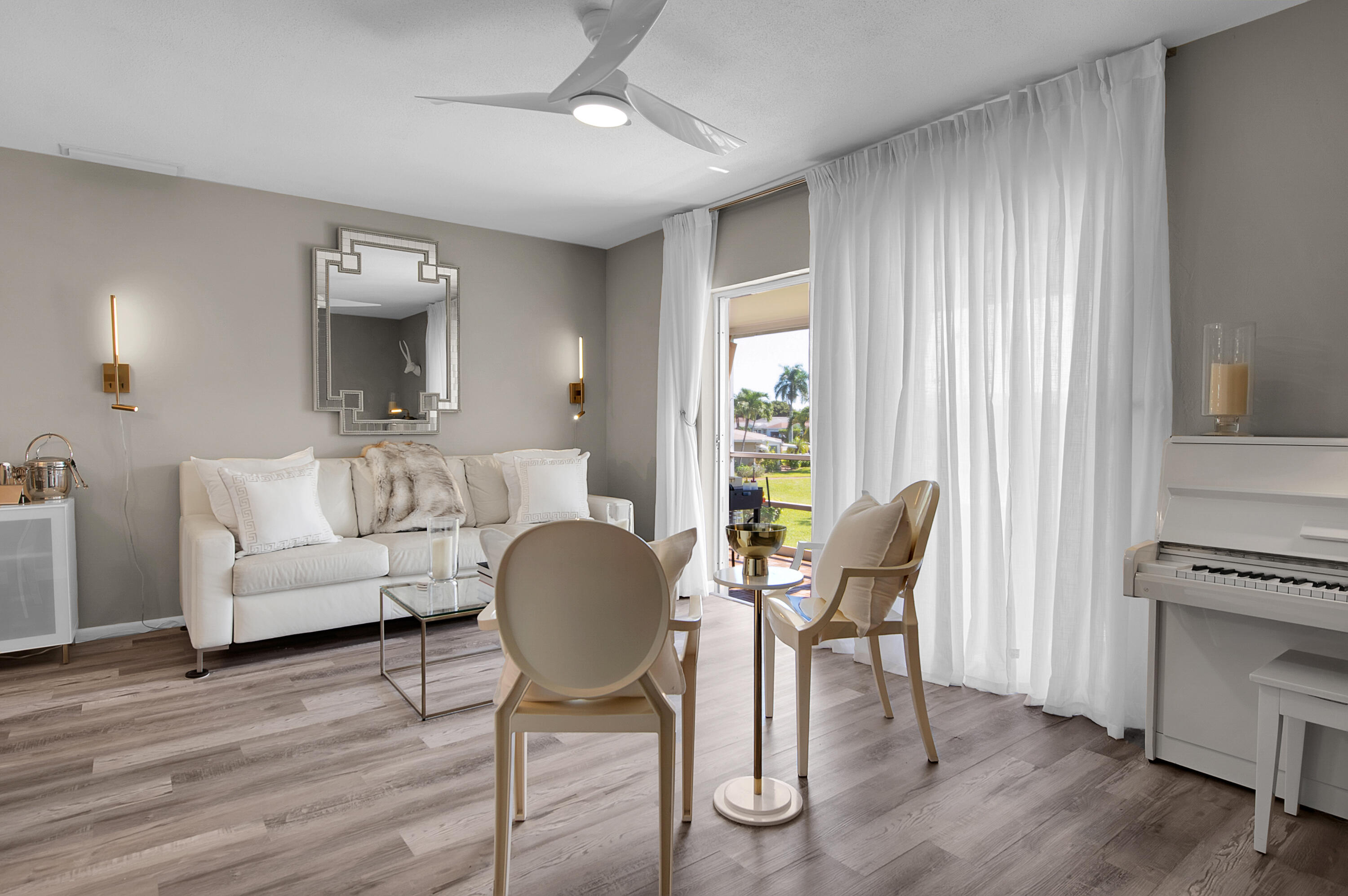 312 Northeast 17th Avenue, Unit 202 Boynton Beach, FL 33435 - Photo 2 of 44 a living room with furniture and a wooden floor