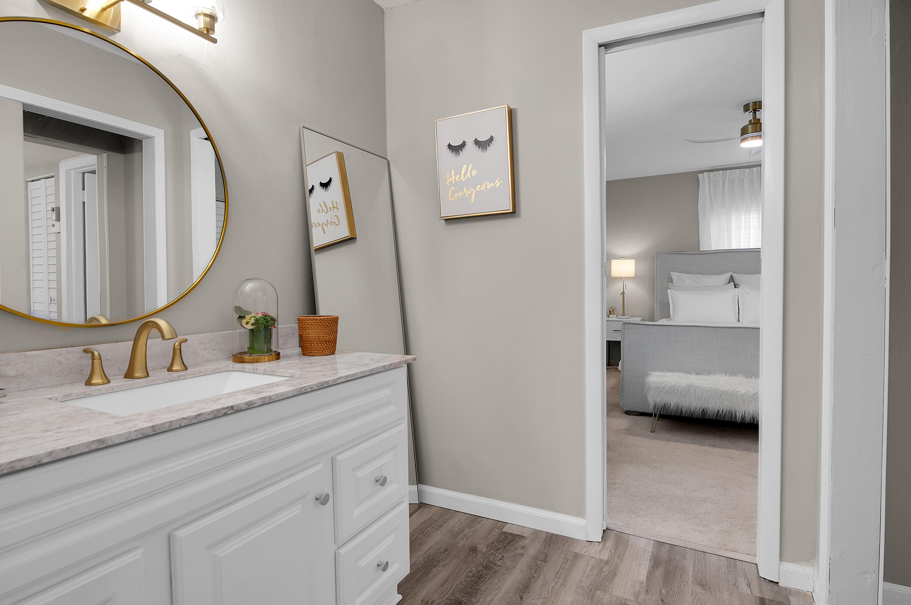 312 Northeast 17th Avenue, Unit 202 Boynton Beach, FL 33435 - Photo 22 of 44 a en suite bathroom with a granite countertop sink and a mirror