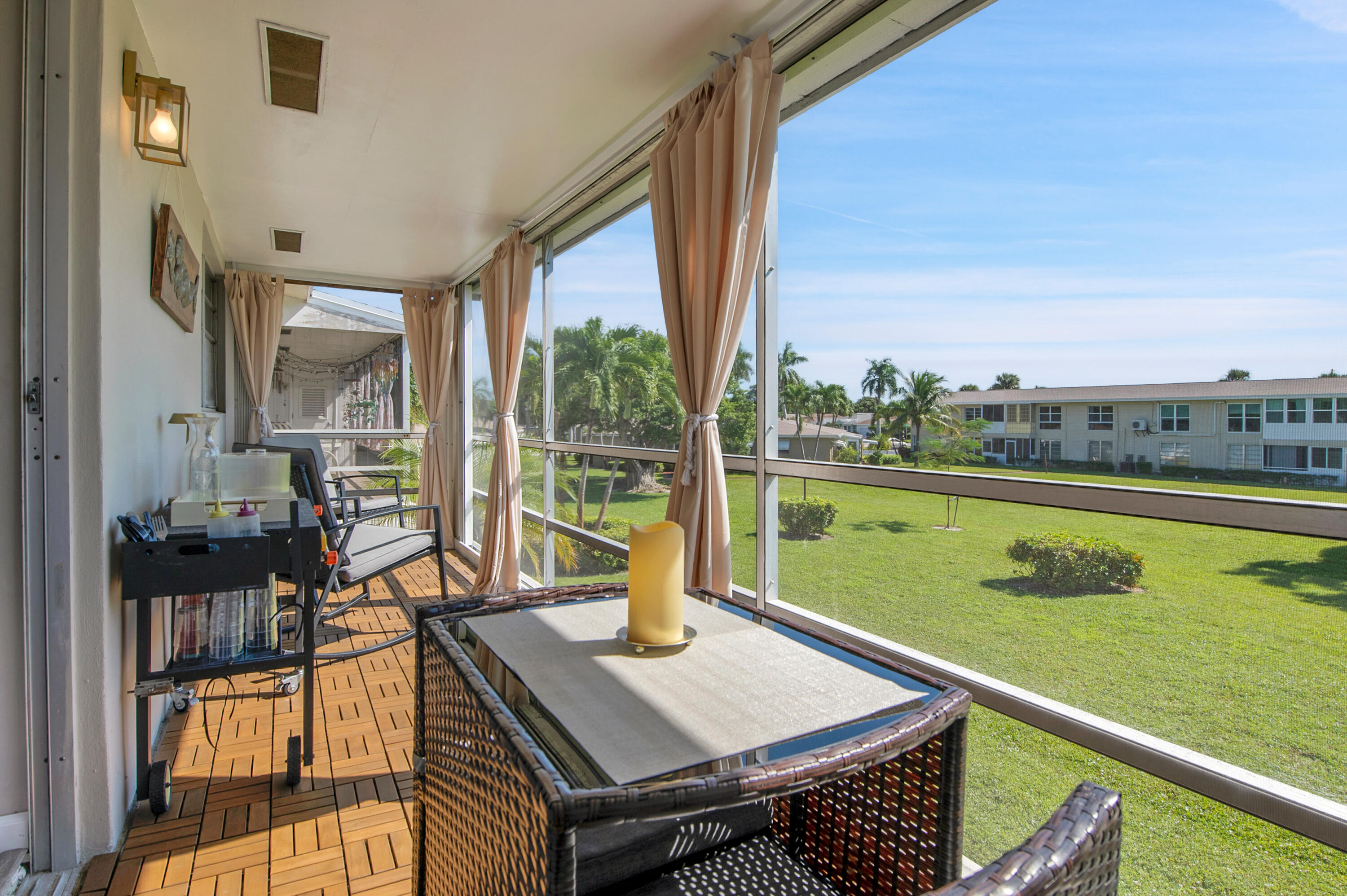 312 Northeast 17th Avenue, Unit 202 Boynton Beach, FL 33435 - Photo 25 of 44 a view of a balcony with lake view and a floor to ceiling window