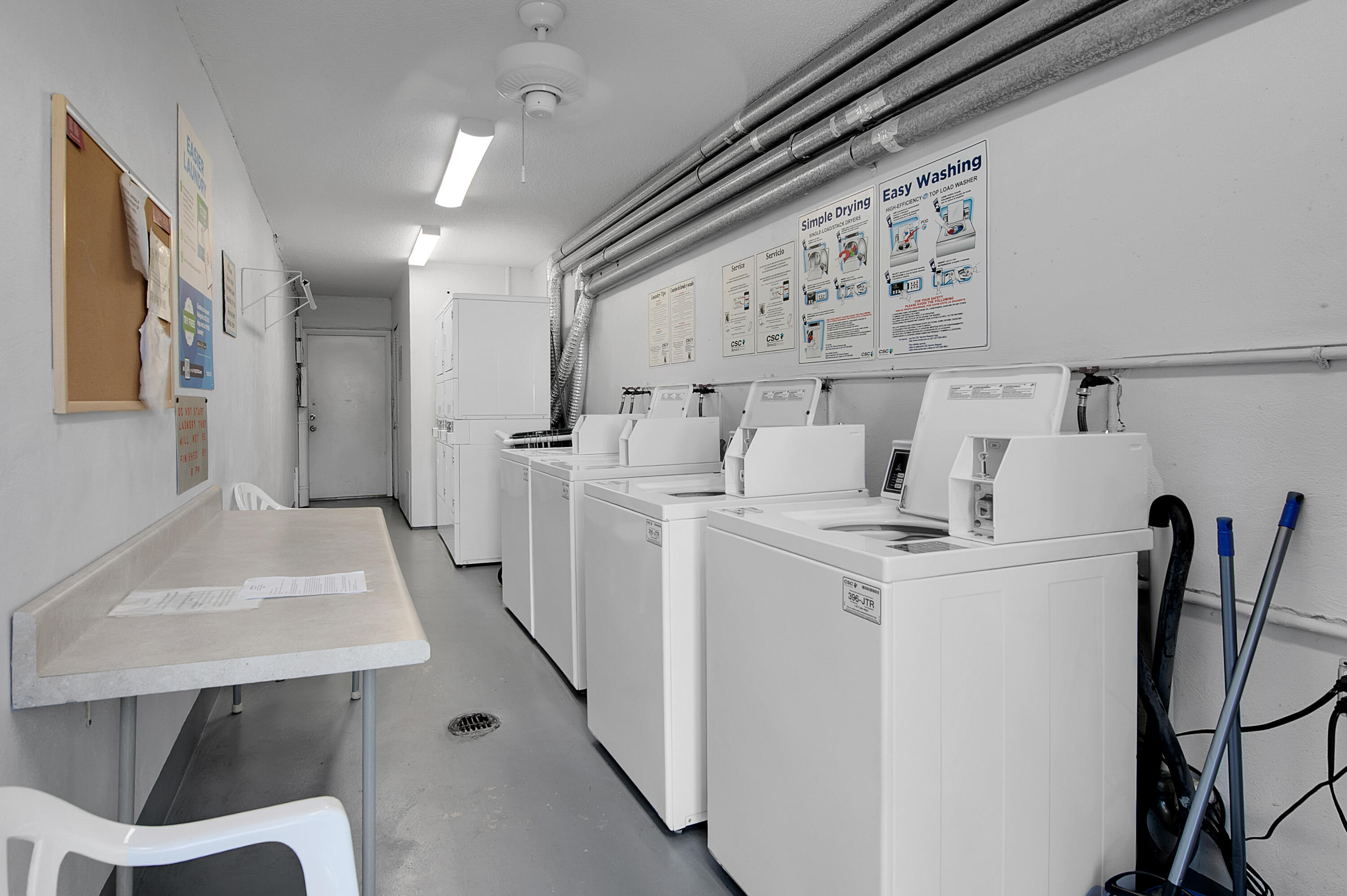 312 Northeast 17th Avenue, Unit 202 Boynton Beach, FL 33435 - Photo 27 of 44 a room with dryer and washer