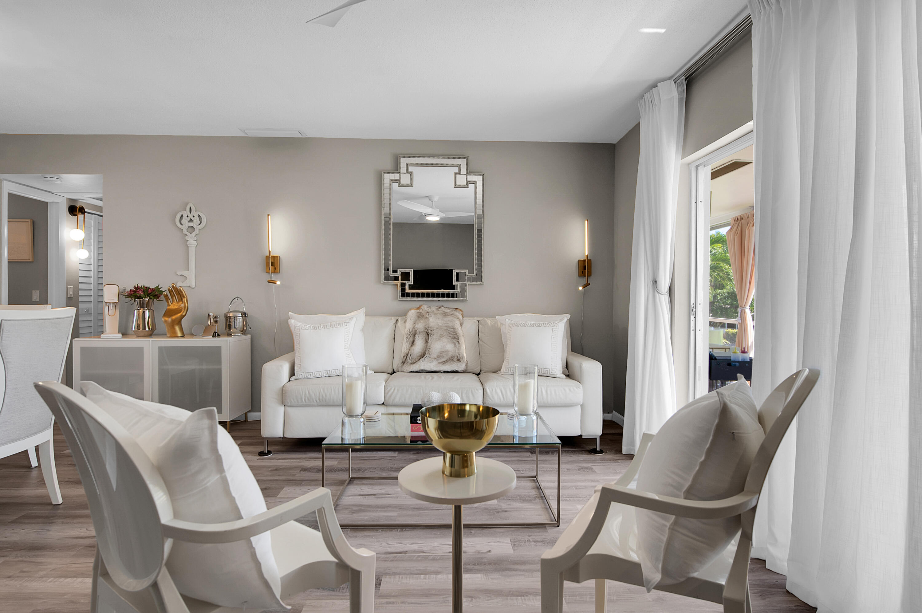 312 Northeast 17th Avenue, Unit 202 Boynton Beach, FL 33435 - Photo 3 of 44 a living room with furniture and a potted plant