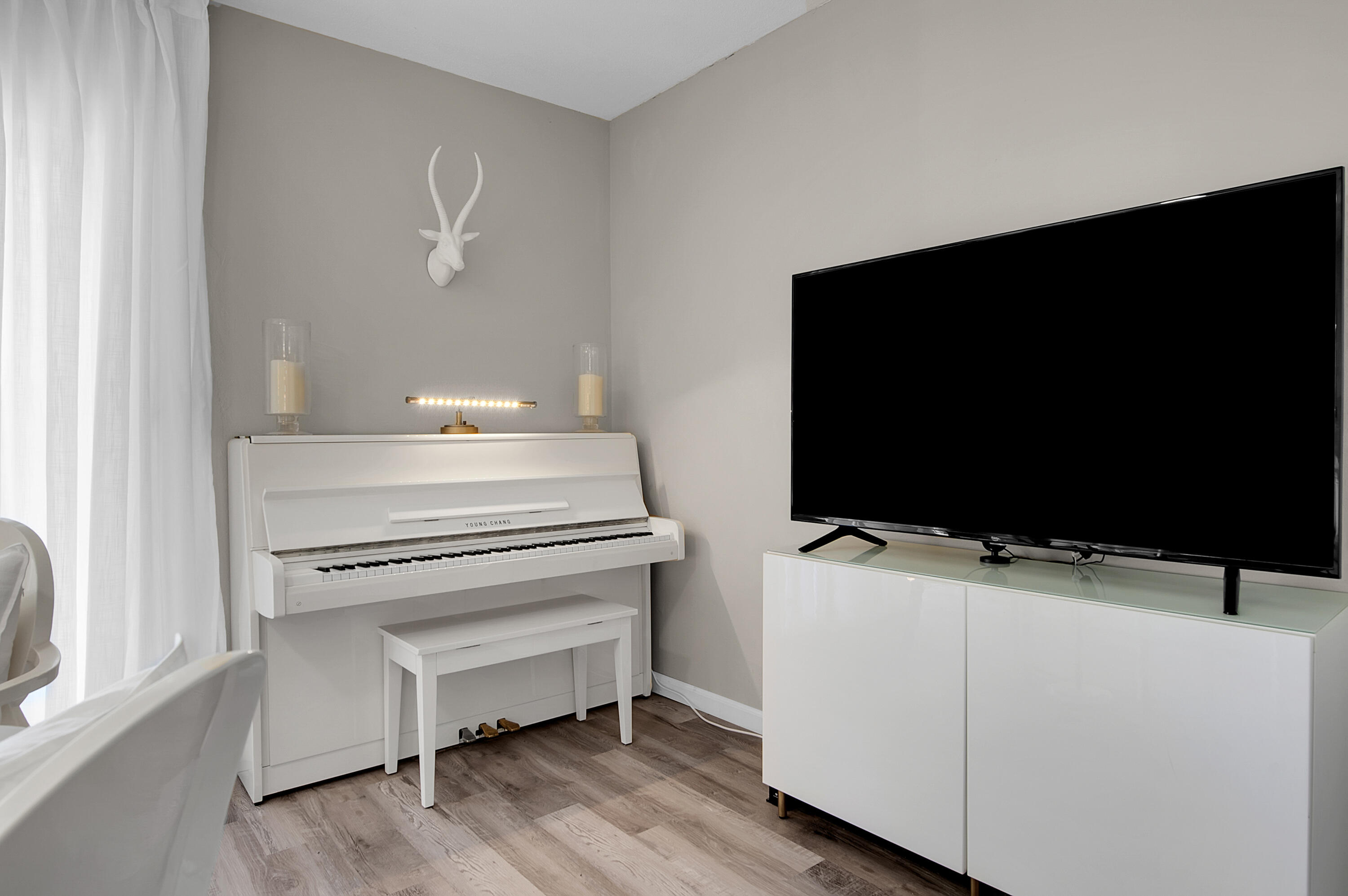 312 Northeast 17th Avenue, Unit 202 Boynton Beach, FL 33435 - Photo 4 of 44 a living room with furniture and a flat screen tv