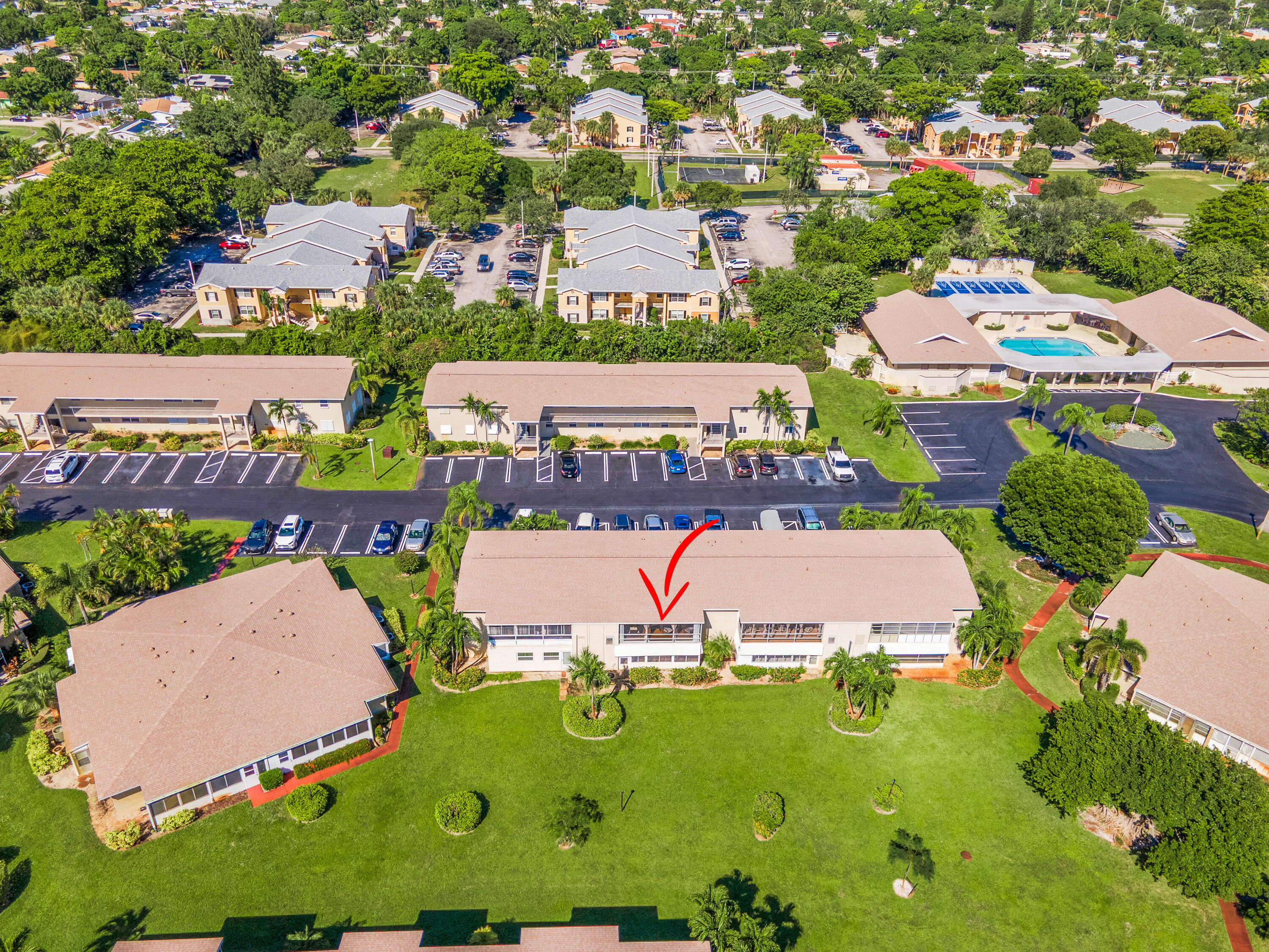 312 Northeast 17th Avenue, Unit 202 Boynton Beach, FL 33435 - Photo 41 of 44 an aerial view of a pool patio swimming pool and outdoor seating