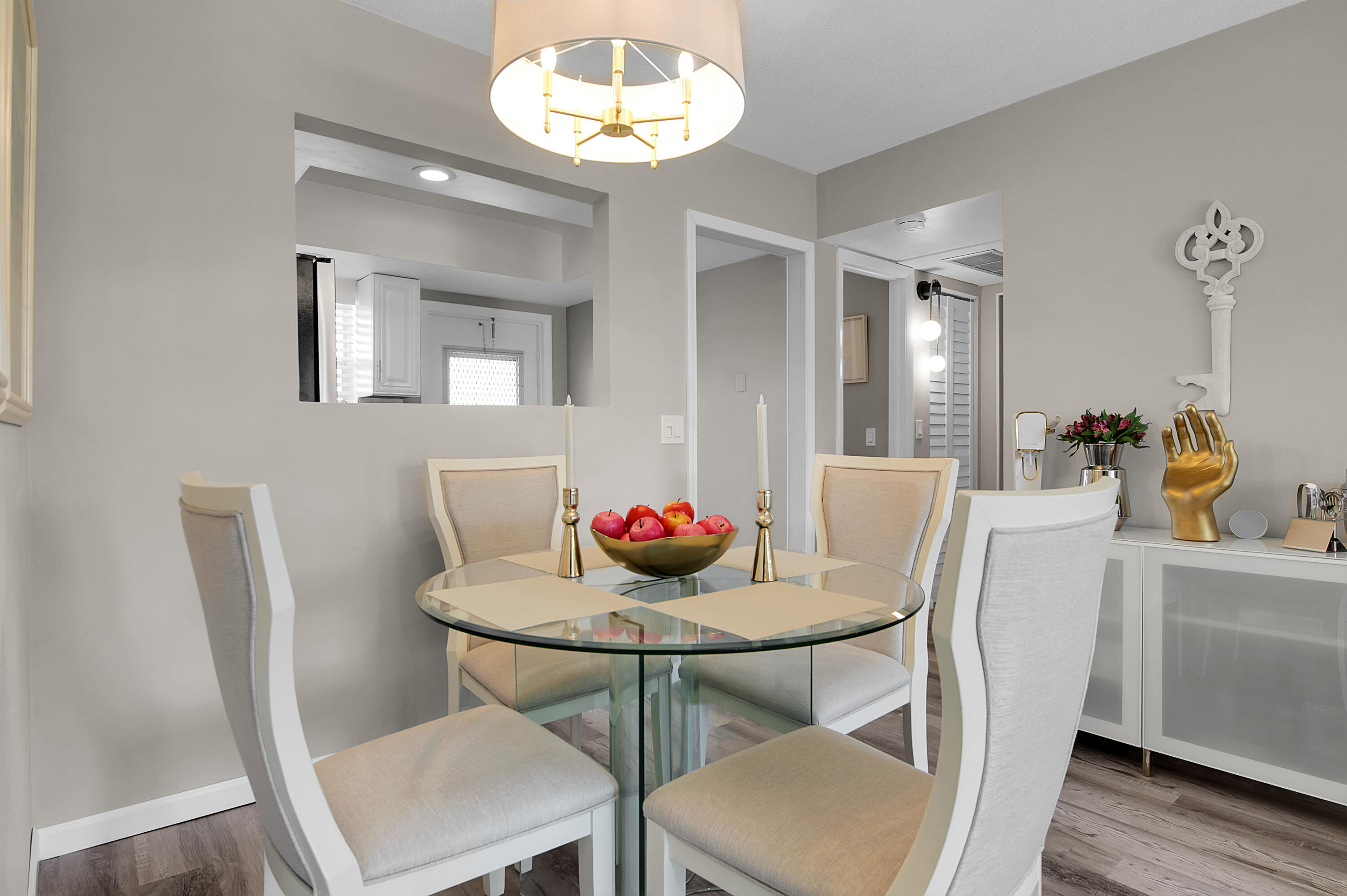 312 Northeast 17th Avenue, Unit 202 Boynton Beach, FL 33435 - Photo 6 of 44 a view of a dining room with furniture and wooden floor