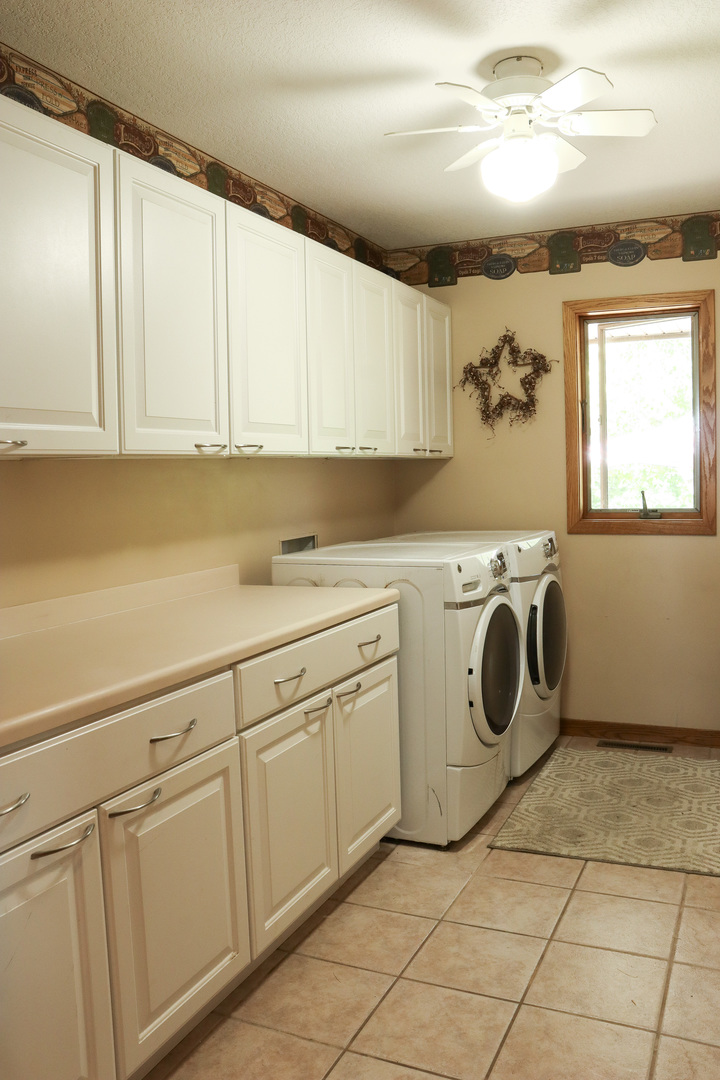 16181 Sand Road Fulton, IL 61252 - Photo 16 of 57 a utility room with cabinets washer and dryer