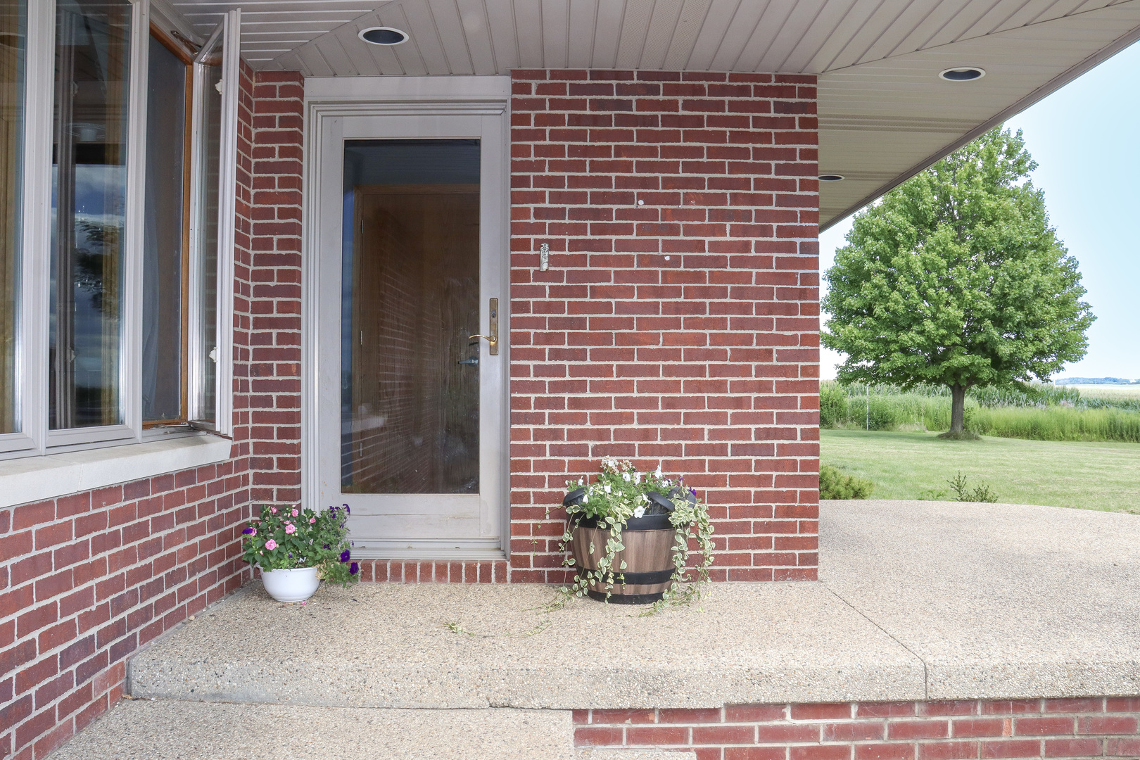 16181 Sand Road Fulton, IL 61252 - Photo 2 of 57 a view of a brick house with a patio