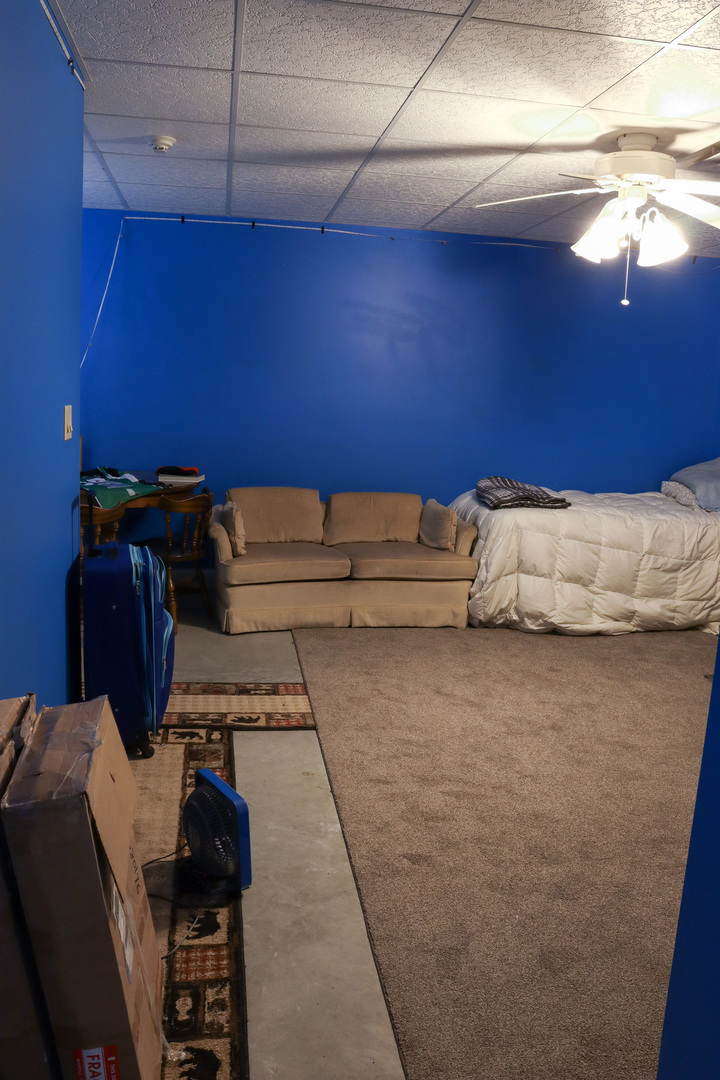 16181 Sand Road Fulton, IL 61252 - Photo 37 of 57 a bed sitting in a room next to a lamp