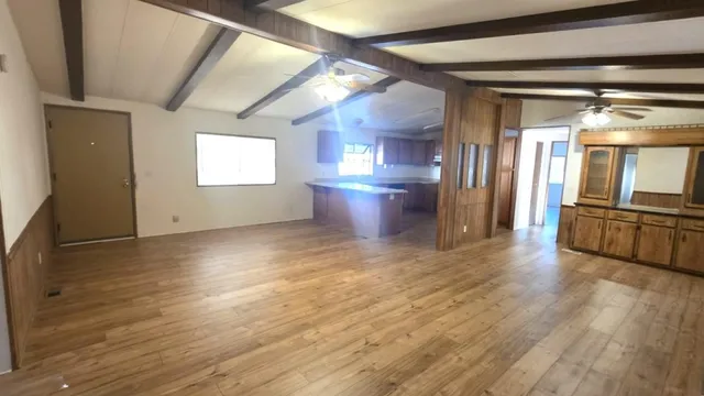 a view of a kitchen with a sink and a refrigerator