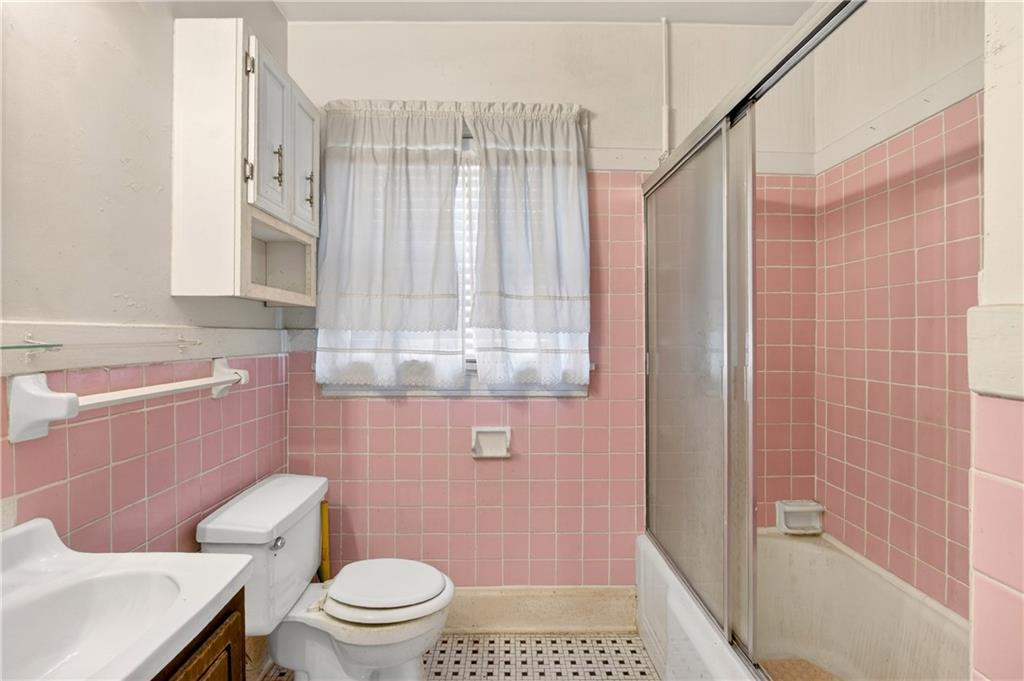 804 Berkeley Avenue Northwest Atlanta, GA 30318 - Photo 12 of 21 a bathroom with a shower a toilet and a sink