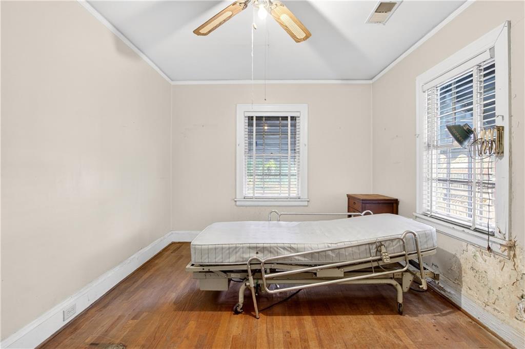 804 Berkeley Avenue Northwest Atlanta, GA 30318 - Photo 14 of 21 a bedroom with a bed and wooden floor