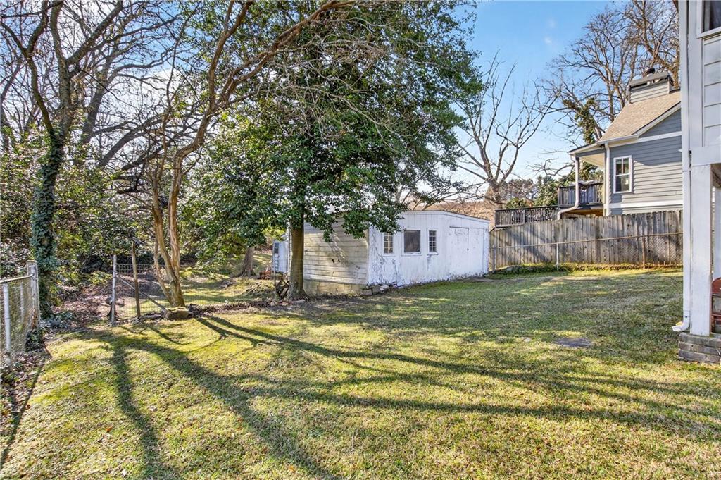 804 Berkeley Avenue Northwest Atlanta, GA 30318 - Photo 19 of 21 a view of a yard with a house in the background