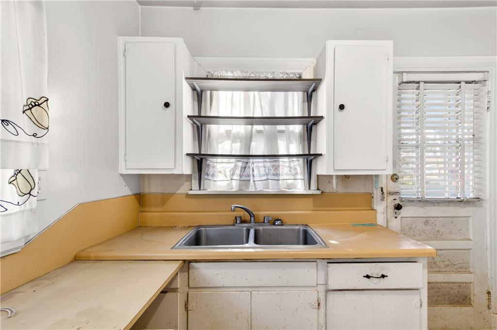 804 Berkeley Avenue Northwest Atlanta, GA 30318 - Photo 8 of 21 a kitchen with a sink cabinets and a window