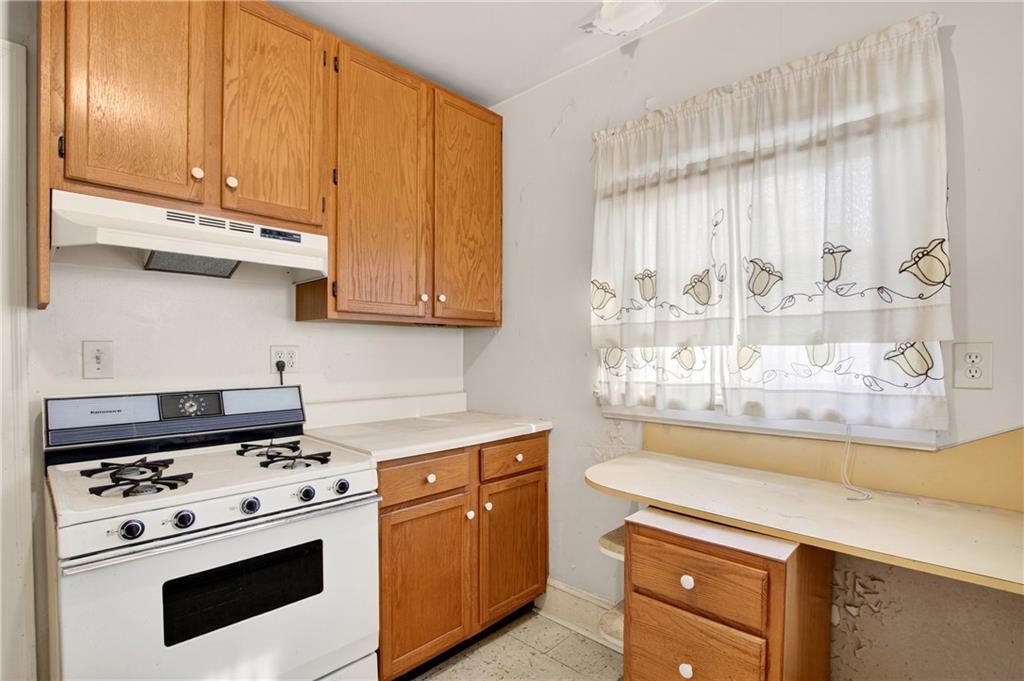 804 Berkeley Avenue Northwest Atlanta, GA 30318 - Photo 9 of 21 a kitchen with stainless steel appliances a stove a microwave and cabinets