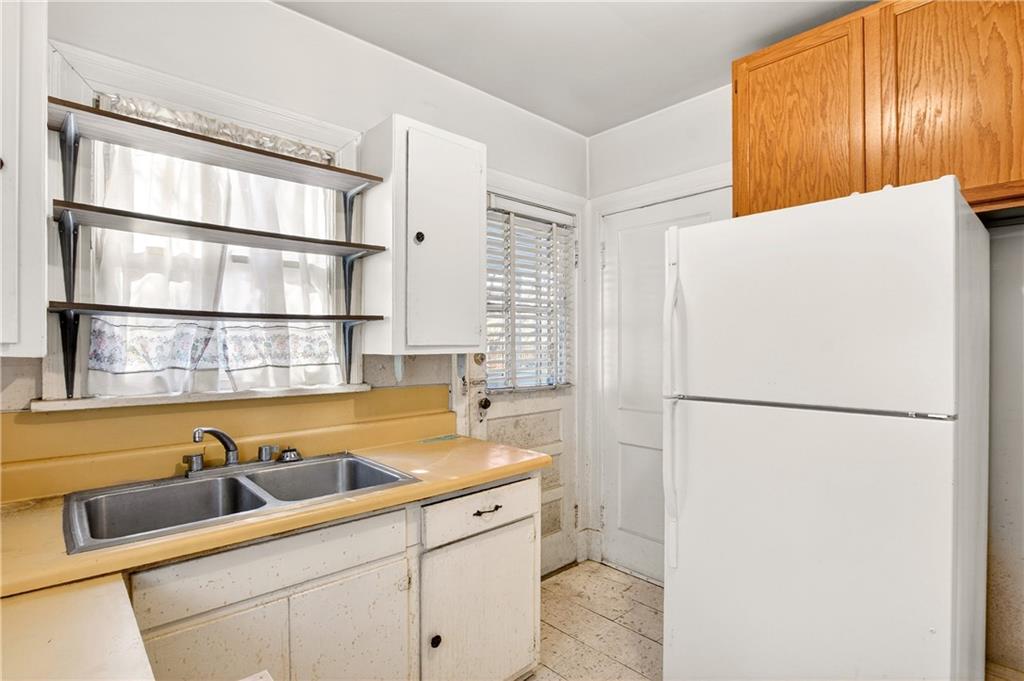 804 Berkeley Avenue Northwest Atlanta, GA 30318 - Photo 10 of 21 a kitchen with a refrigerator and a sink