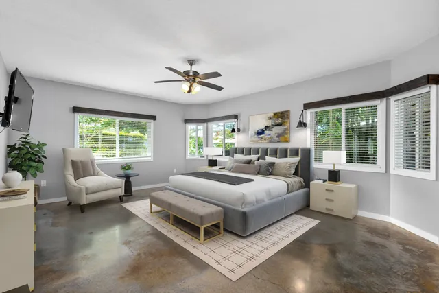 a bedroom with a large bed and a couch