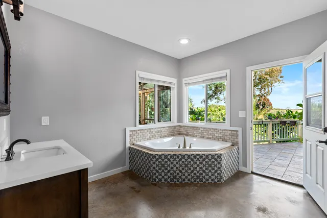 a living room with a large window and tub