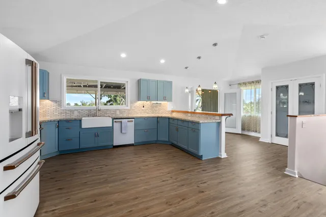 a kitchen with stainless steel appliances kitchen island wooden cabinets and granite counter tops