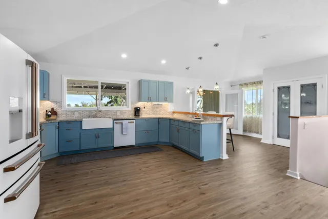a large kitchen with a center island and stainless steel appliances