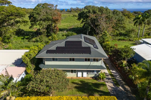a aerial view of a house with a yard