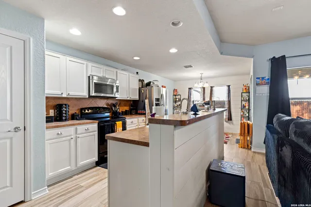 a kitchen with counter top space a sink cabinets and appliances