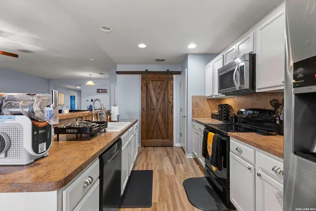 a kitchen with lots of appliances and cabinets
