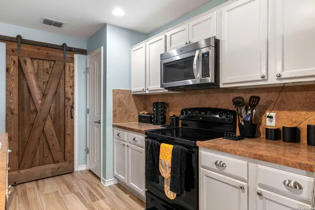 a kitchen with stainless steel appliances granite countertop a refrigerator and microwave